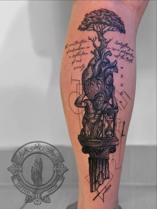 Calf tattoo of Atlas carrying an anatomical heart, with a tree growing from it and script lines