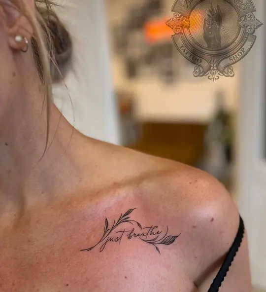 Fine line script tattoo on shoulder